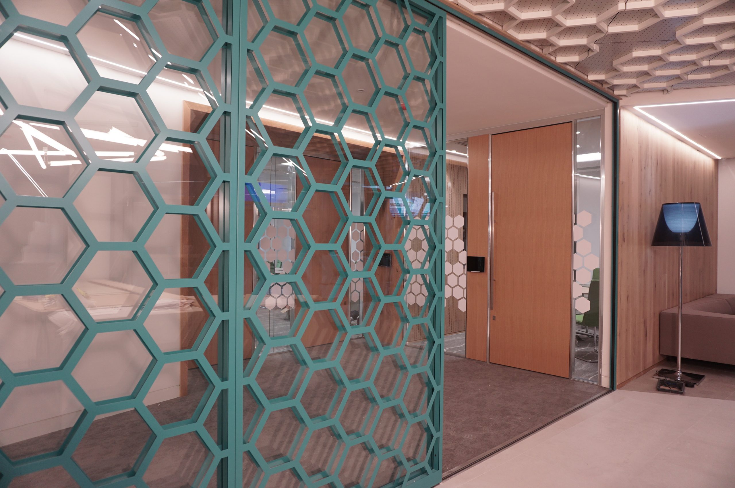 Steel framed panels with bespoke hexagonal pattern cut-outs and finished in corporate colour..